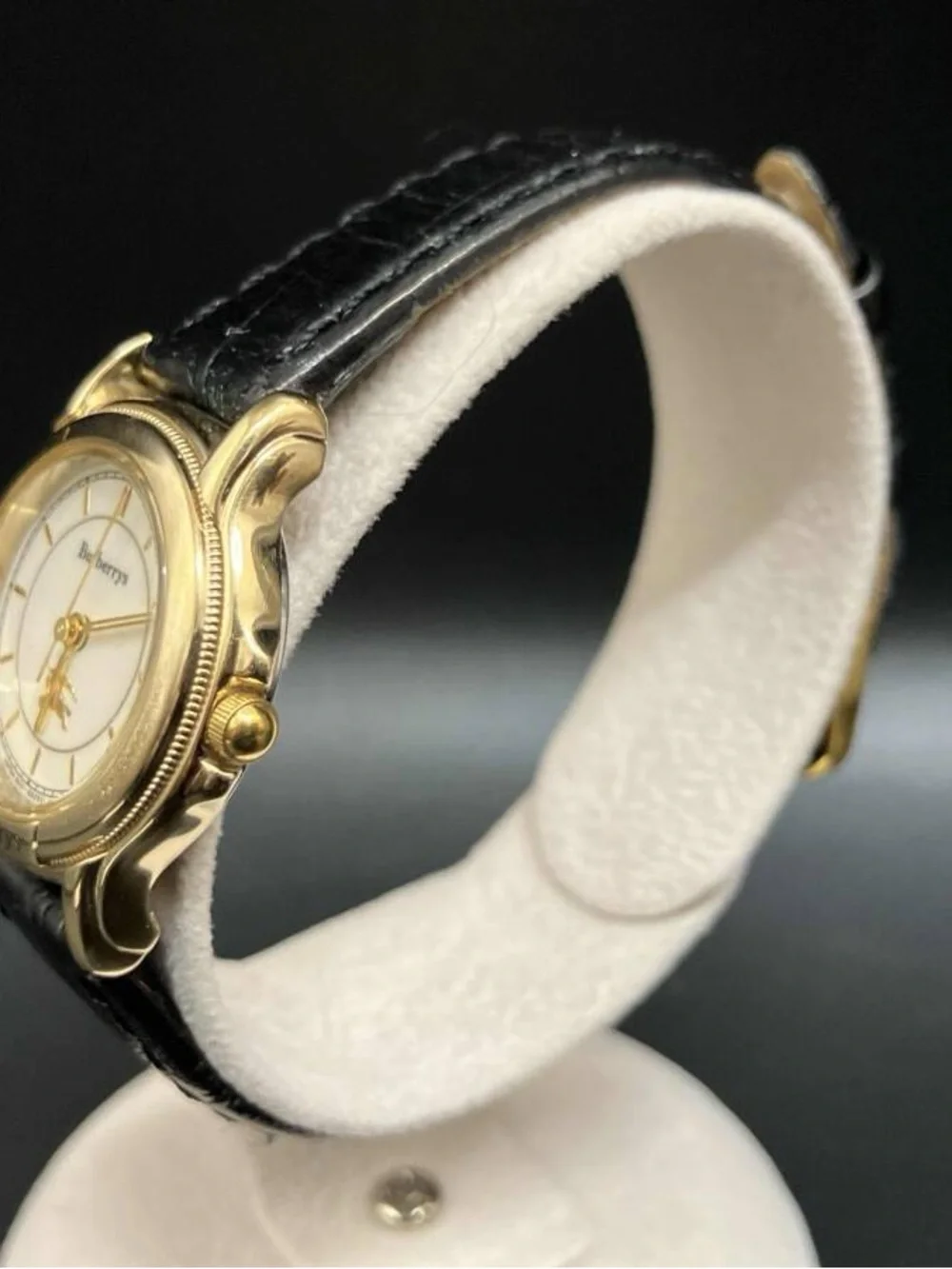 Burberrys Gold Tone Round Watch with Black Leather Strap